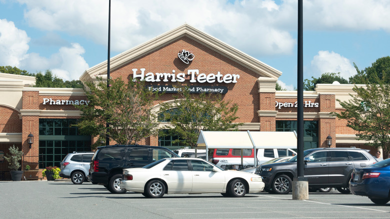 A parking lot in front of a Harris Teeter.