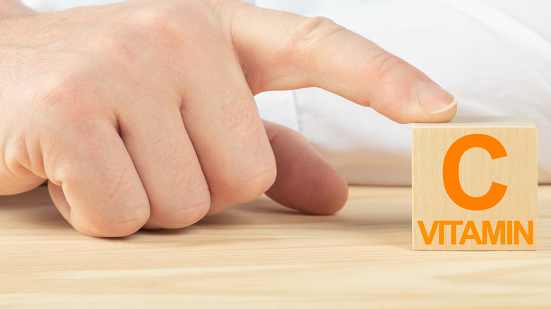 Doctor pointing to a block reading vitamin C