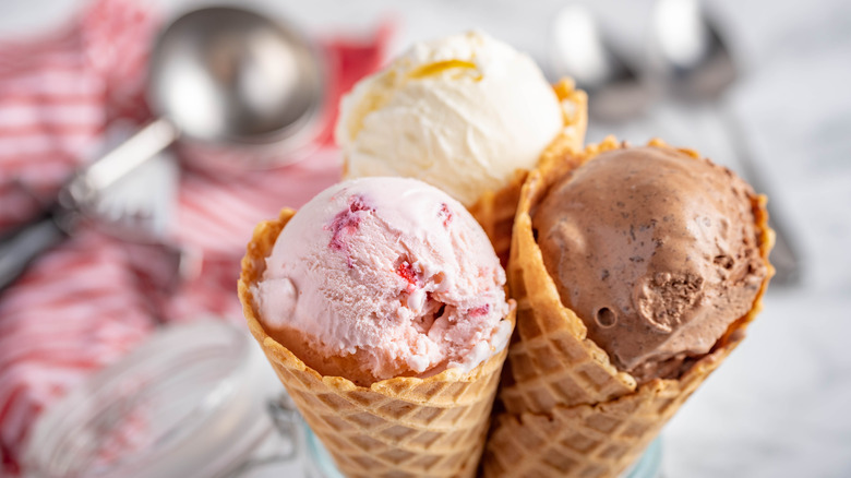 Three ice cream cones by a scoop