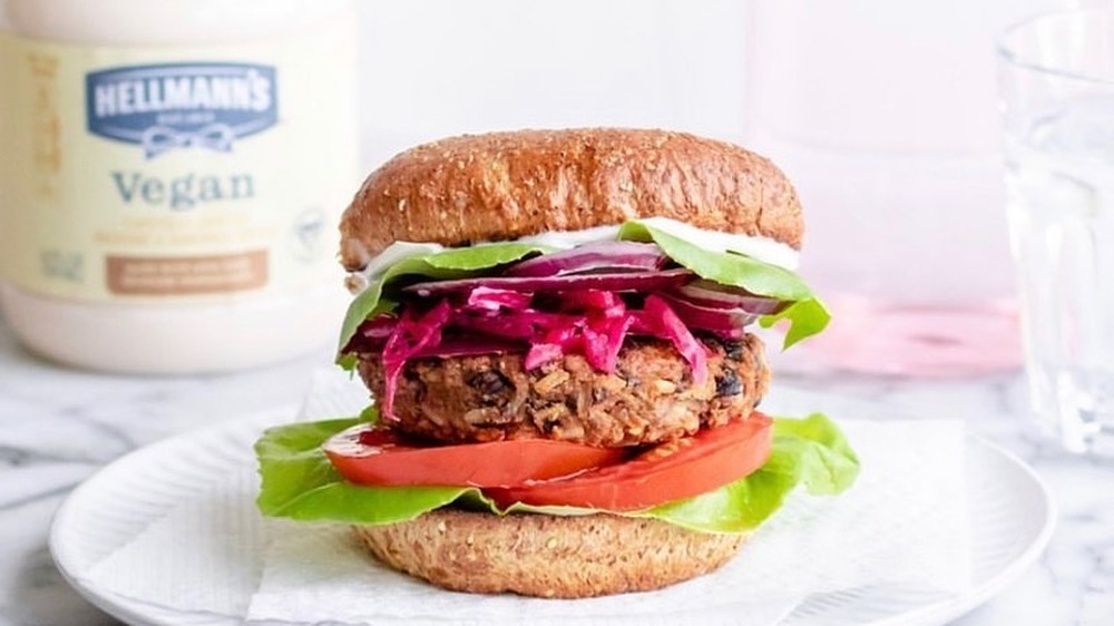 veggie burger with tub of vegan mayo