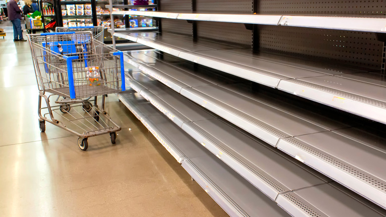 Empty supermarket shelves and trolly