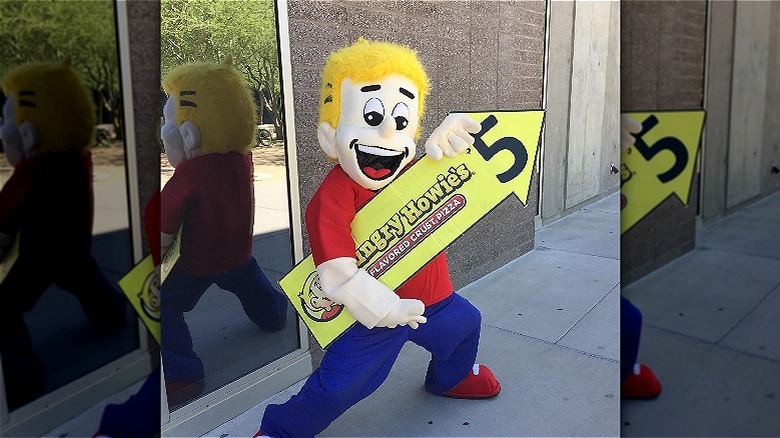 mascot holding sign