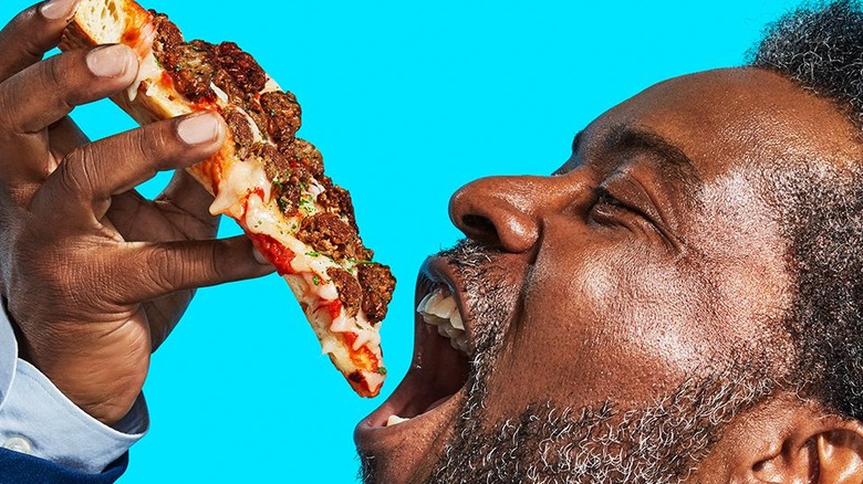 man enjoying impossible pizza