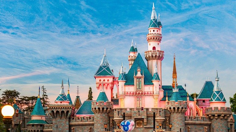 Castle at Disneyland with visitors at its base