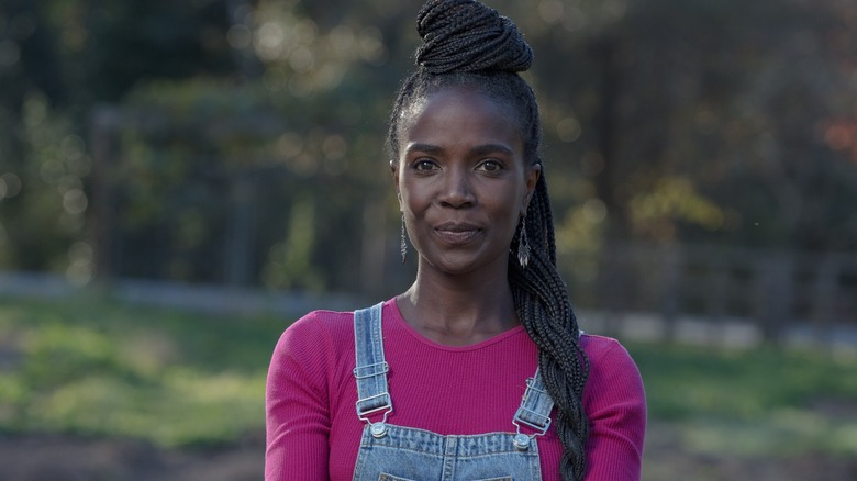 Jamila Norman in pink top and denim overalls