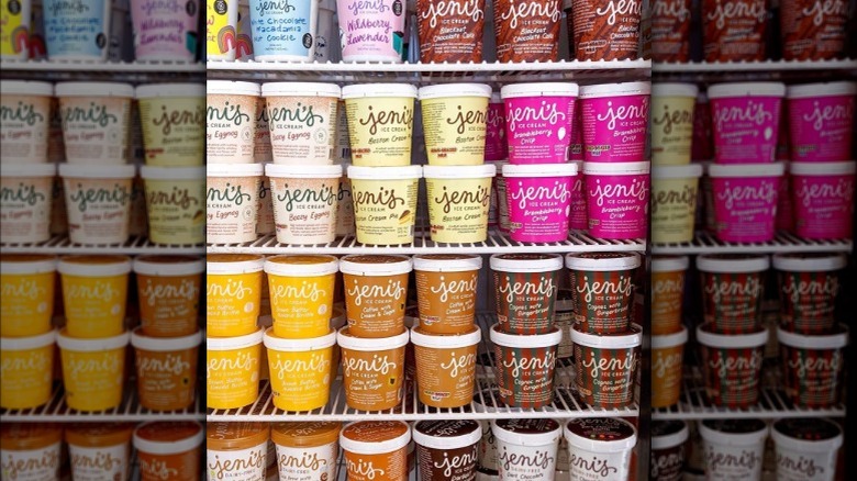 A grocery store freezer shelf stocked with different pints of Jeni's ice cream