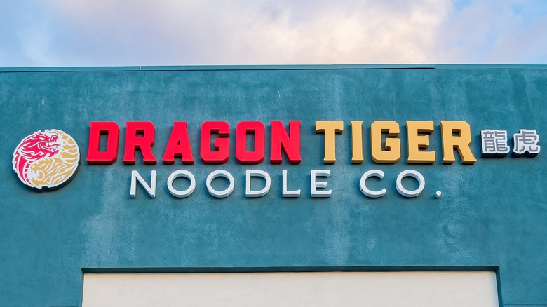 dragon tiger noodle company restaurant signage