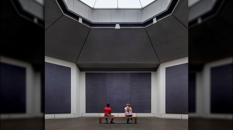 People sitting inside Rothko Chapel in Houston