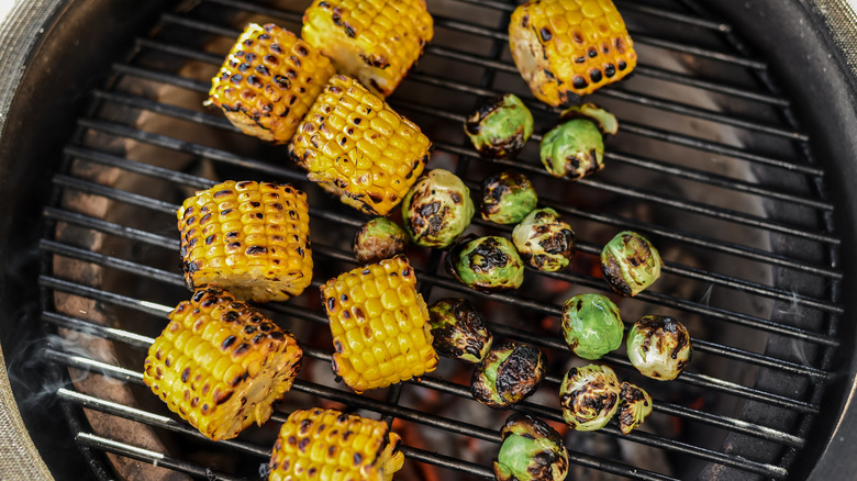 Charred corn and sprouts on a grill