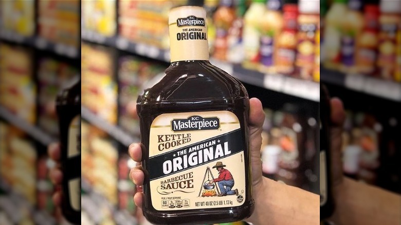 shopper holding KC Masterpiece sauce