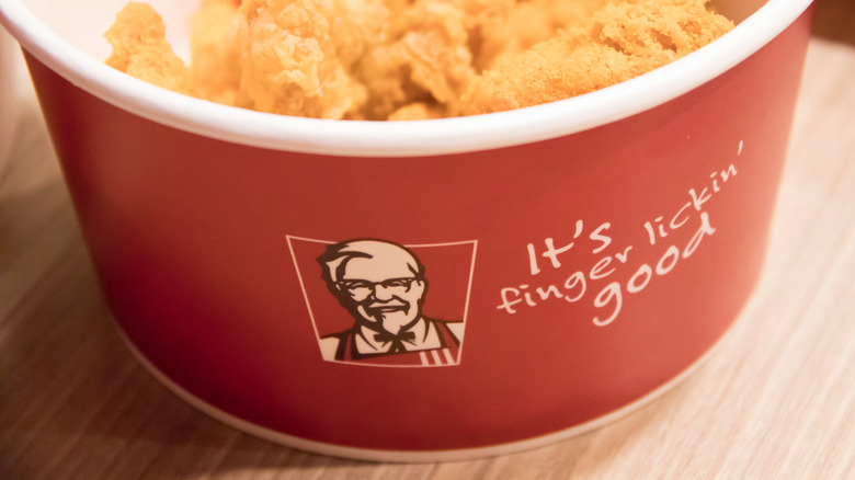 KFC container with "finger lickin' good" slogan