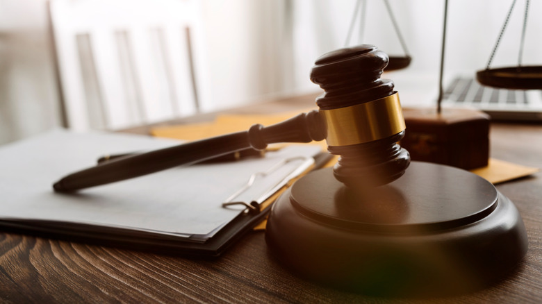 A wooden gavel on a wooden base 