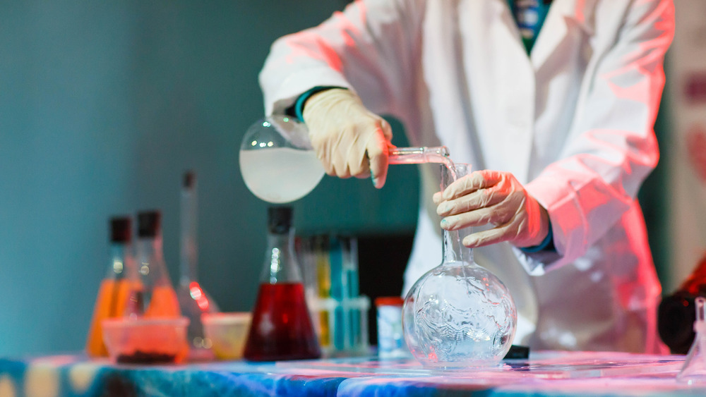 Scientist pouring chemicals