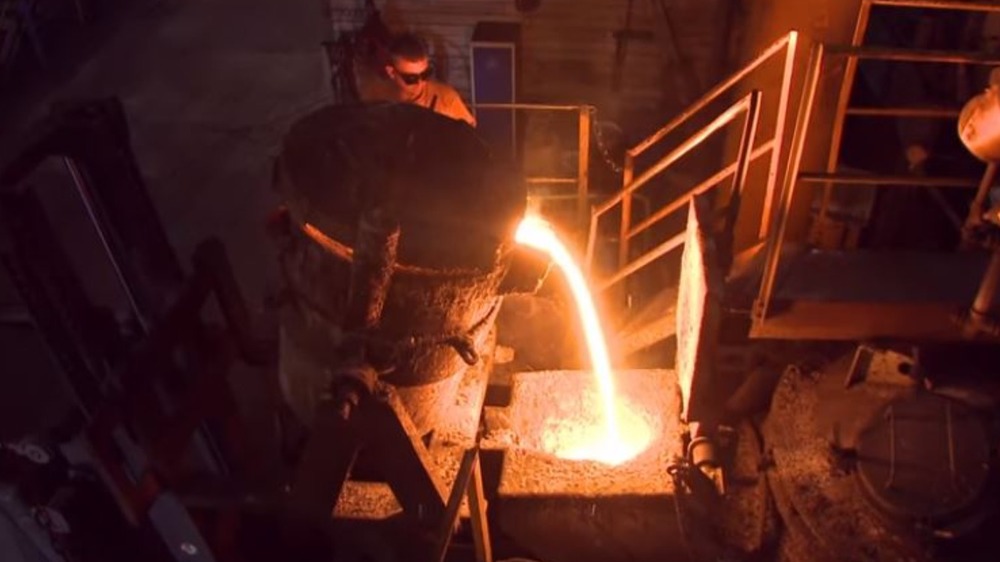 Glowing molten iron being poured into a mold at the Le Creuset foundry. 