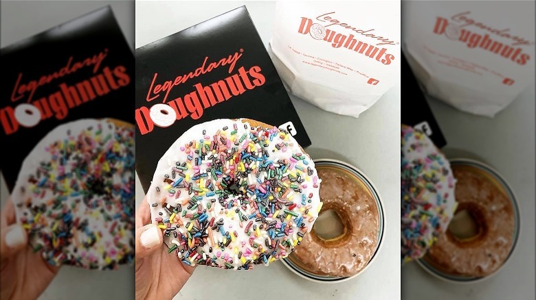 person holding sprinkled doughnut