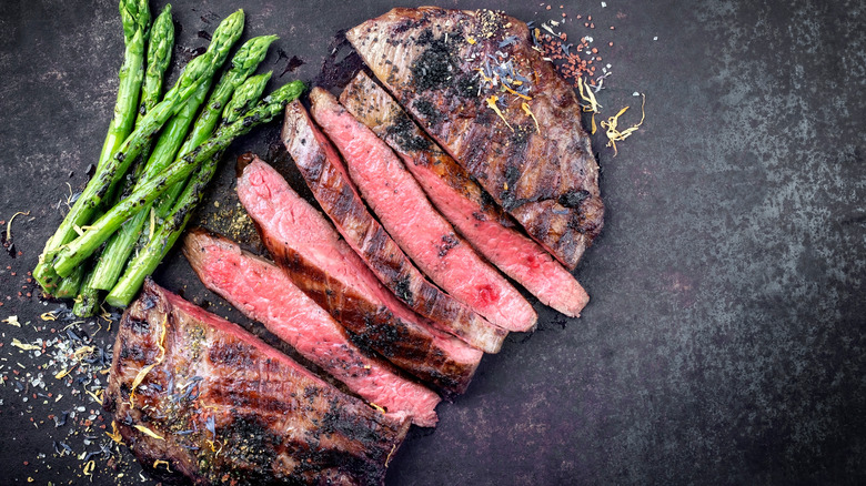 sliced london broil with asparagus