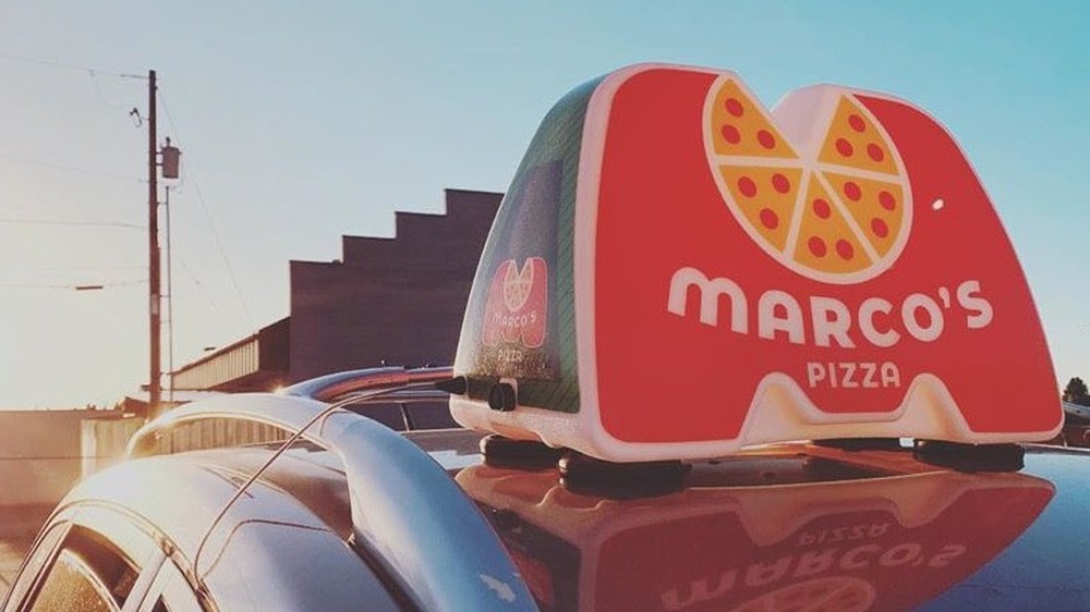 Marco's Pizza delivery sign on car