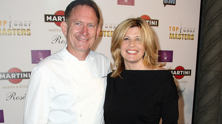 Mark Peel and his wife Daphne Brogdon in front of a Top Chef Masters step and repeat