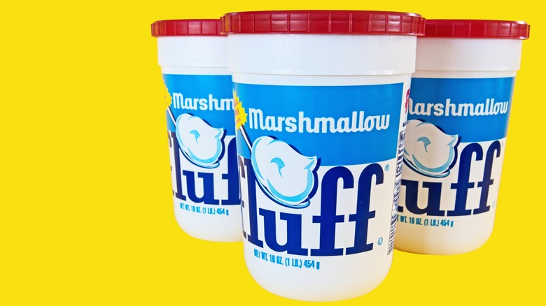 tubs of Marshmallow Fluff on yellow background