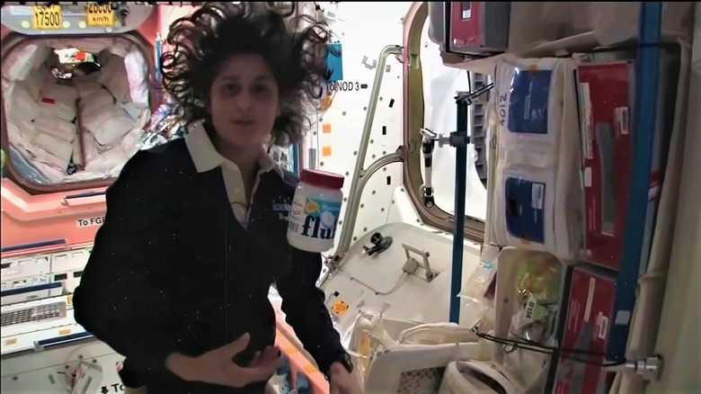 screenshot from YouTube video of astronaut Sonny Williams and jar of Marshmallow Fluff floating inside the International Space Station