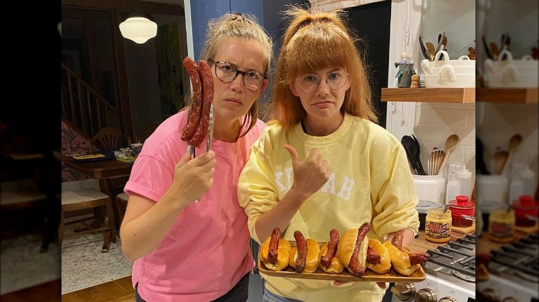 Mary Berg and friend posing with hot dogs