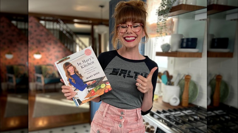 Mary Berg with cookbook 