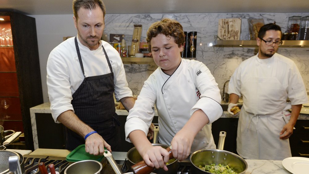 Alexander Weiss cooking in kitchen