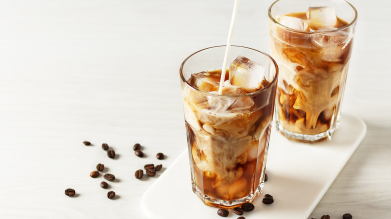 milk pouring into coffee drinks