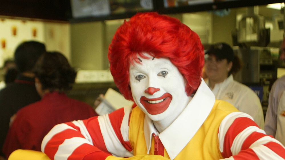 Ronald McDonald at a McDonald's, smiling