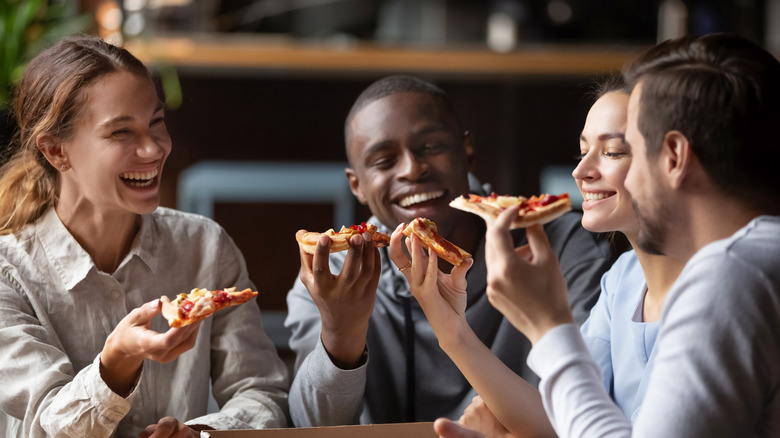 friends eating pizza together