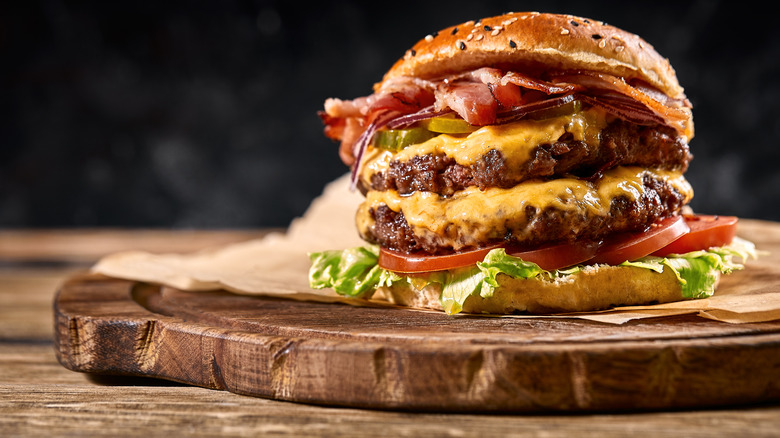 double bacon cheeseburger on cutting board