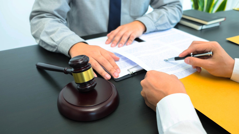 Lawyers signing papers