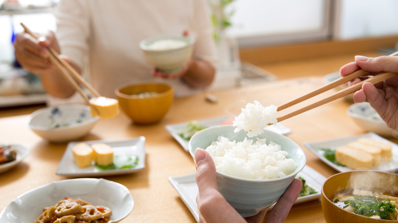 people eating miso soup and rice