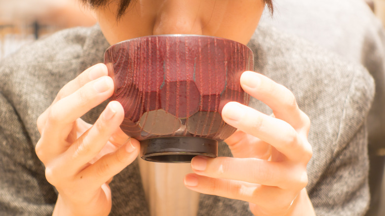 Woman drinking miso soup