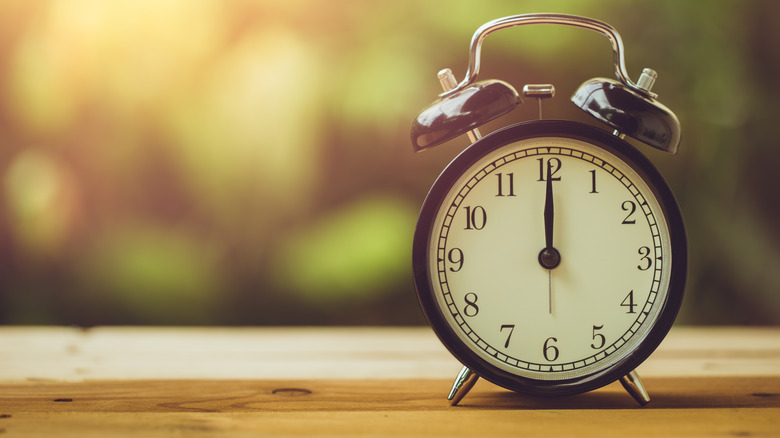 Clock with hands on noon