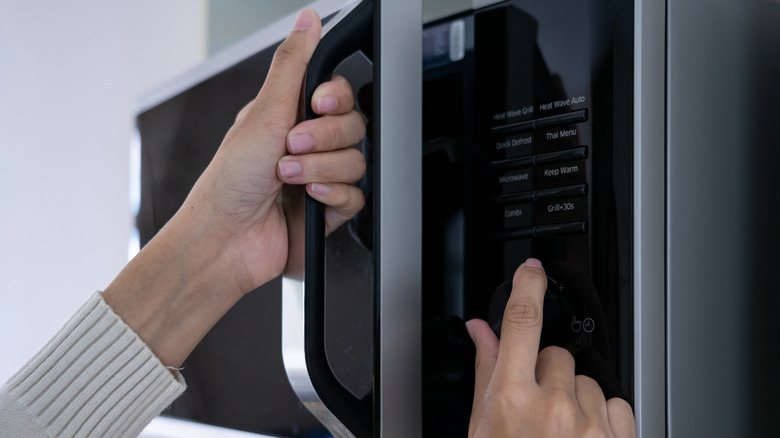 woman using microwave