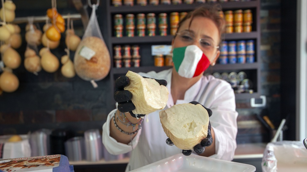 Cheesemonger showing off cheese