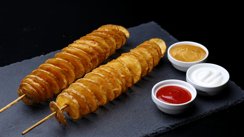 Tornado Potato with sauces on a black slab