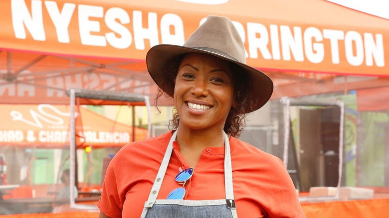 Nyesha Arrington smiling with hat