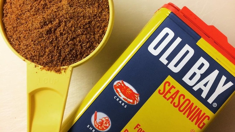 Old bay Seasoning container and yellow measuring cup