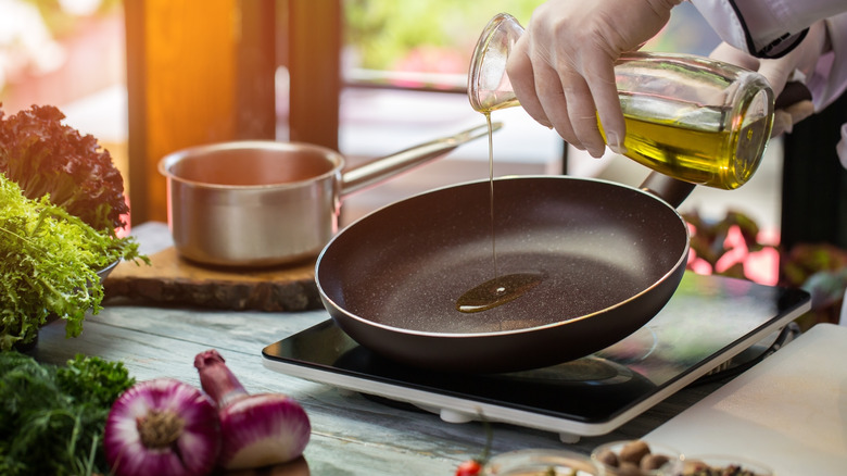 pouring olive oil in pan