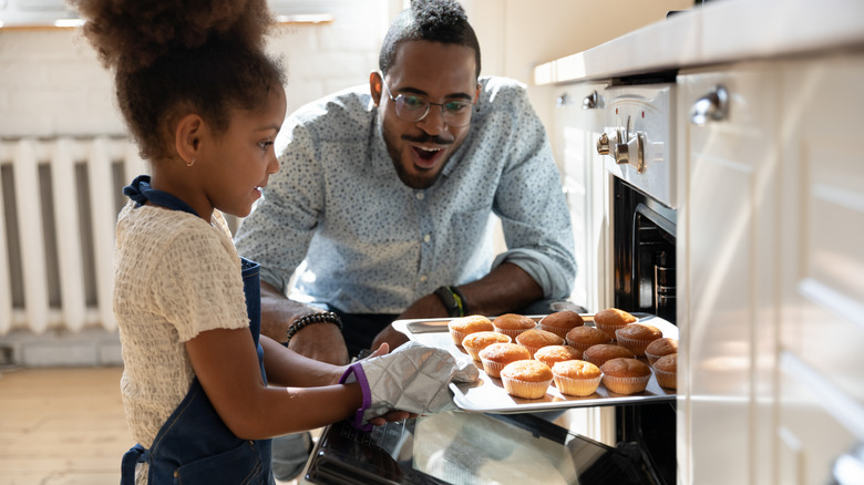 Girl and dad baking muffins