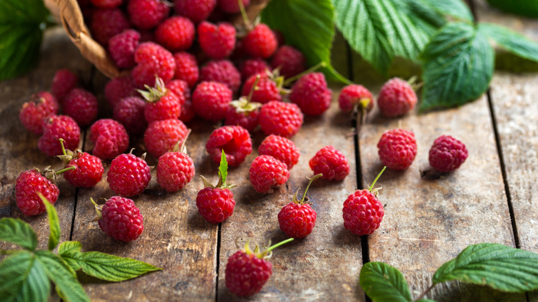 raspberries spilling out of basket