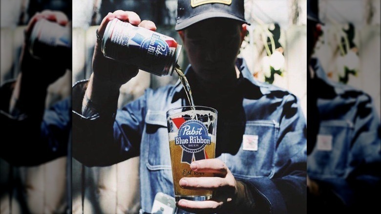 man pouring pabst blue ribbon