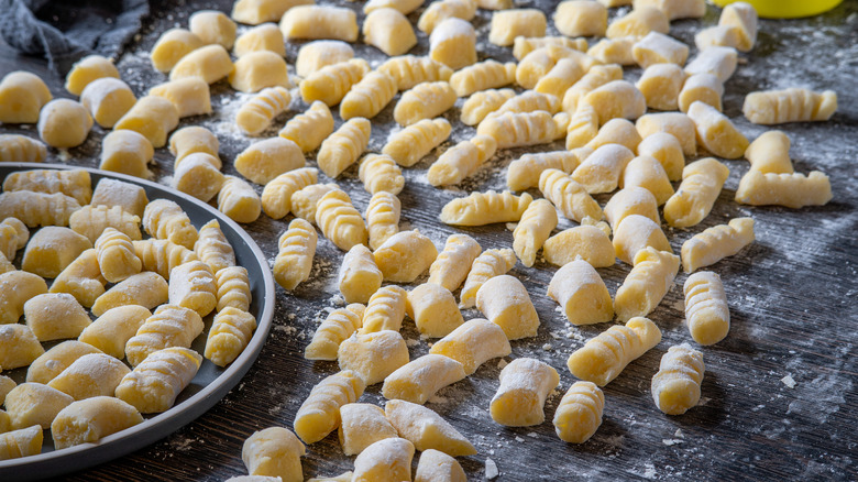 Scattered fresh gnocchi on table