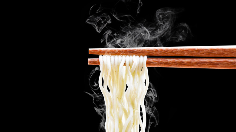 Steaming noodles on chopsticks