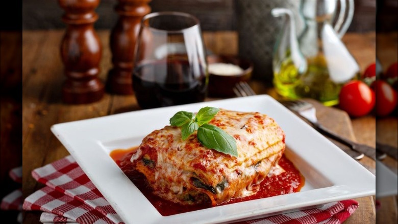 Lasagna on table with wine