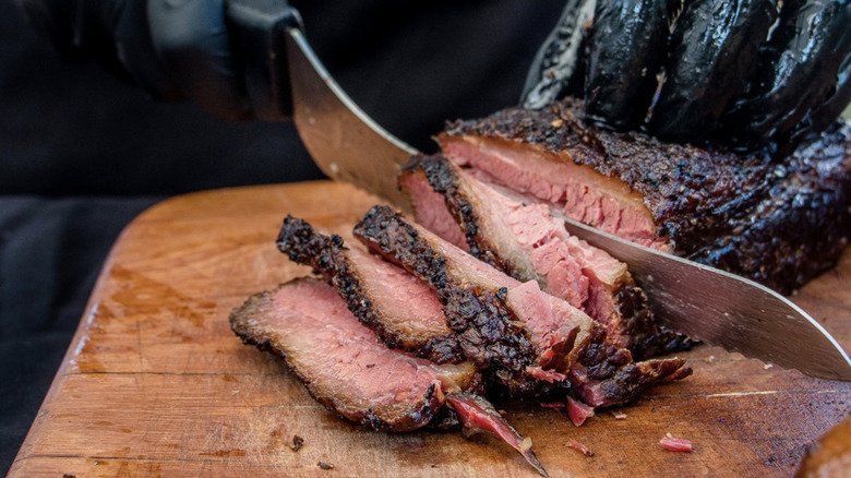 slicing pastrami on board