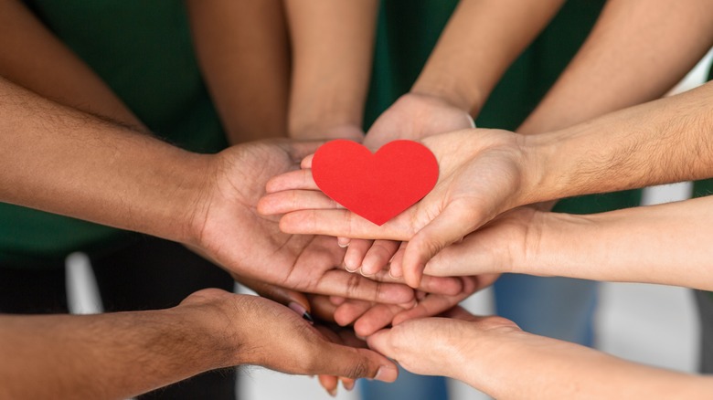 Hands holding heart in solidarity