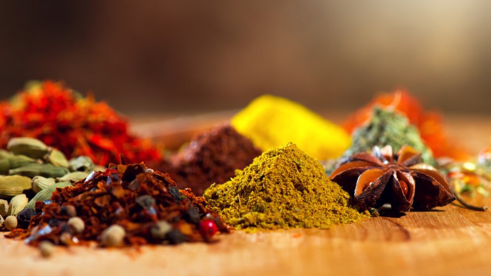Piles of brightly colored whole and ground spices